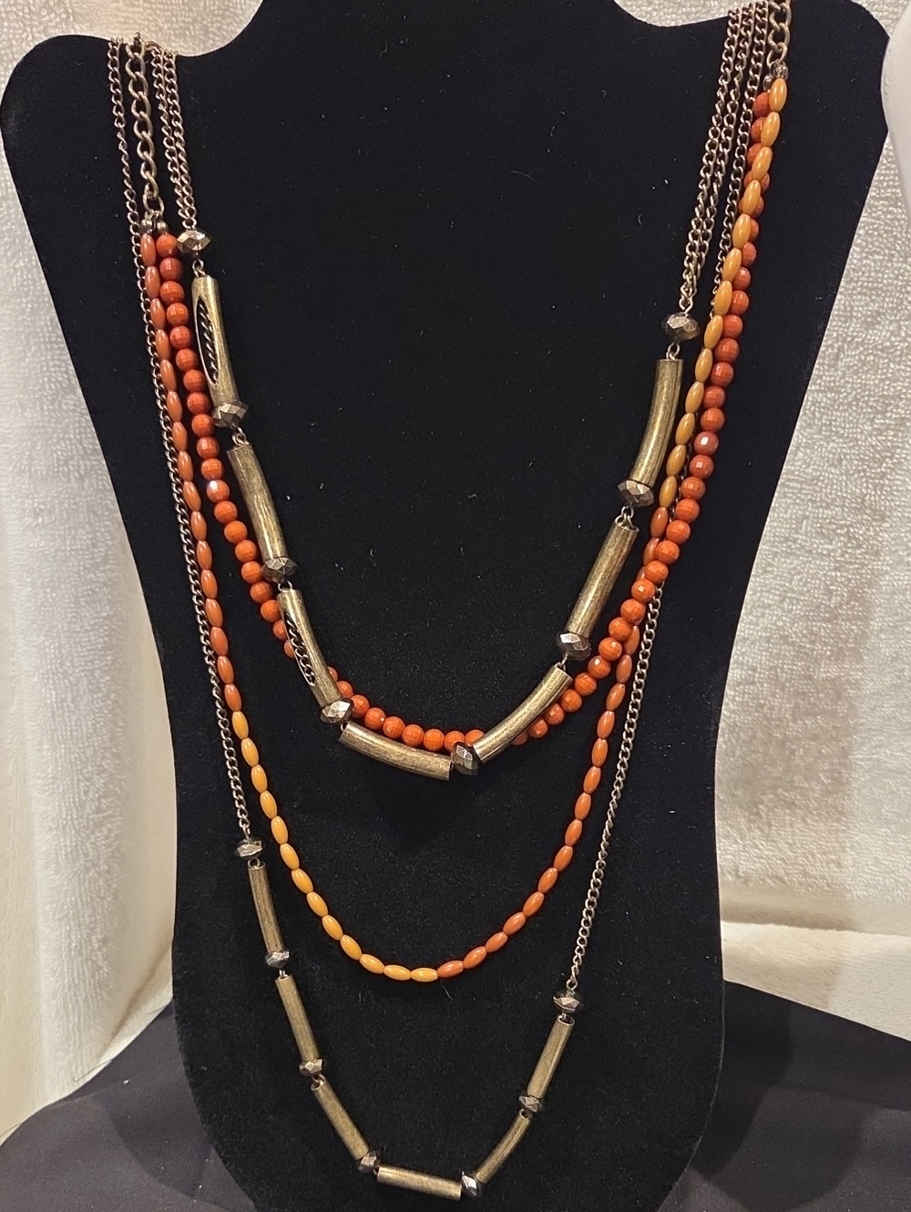 MULTI STRAND NECKLACE WITH MULTI COLOR BEADS AND BRASS LIKE TUBE SPACERS